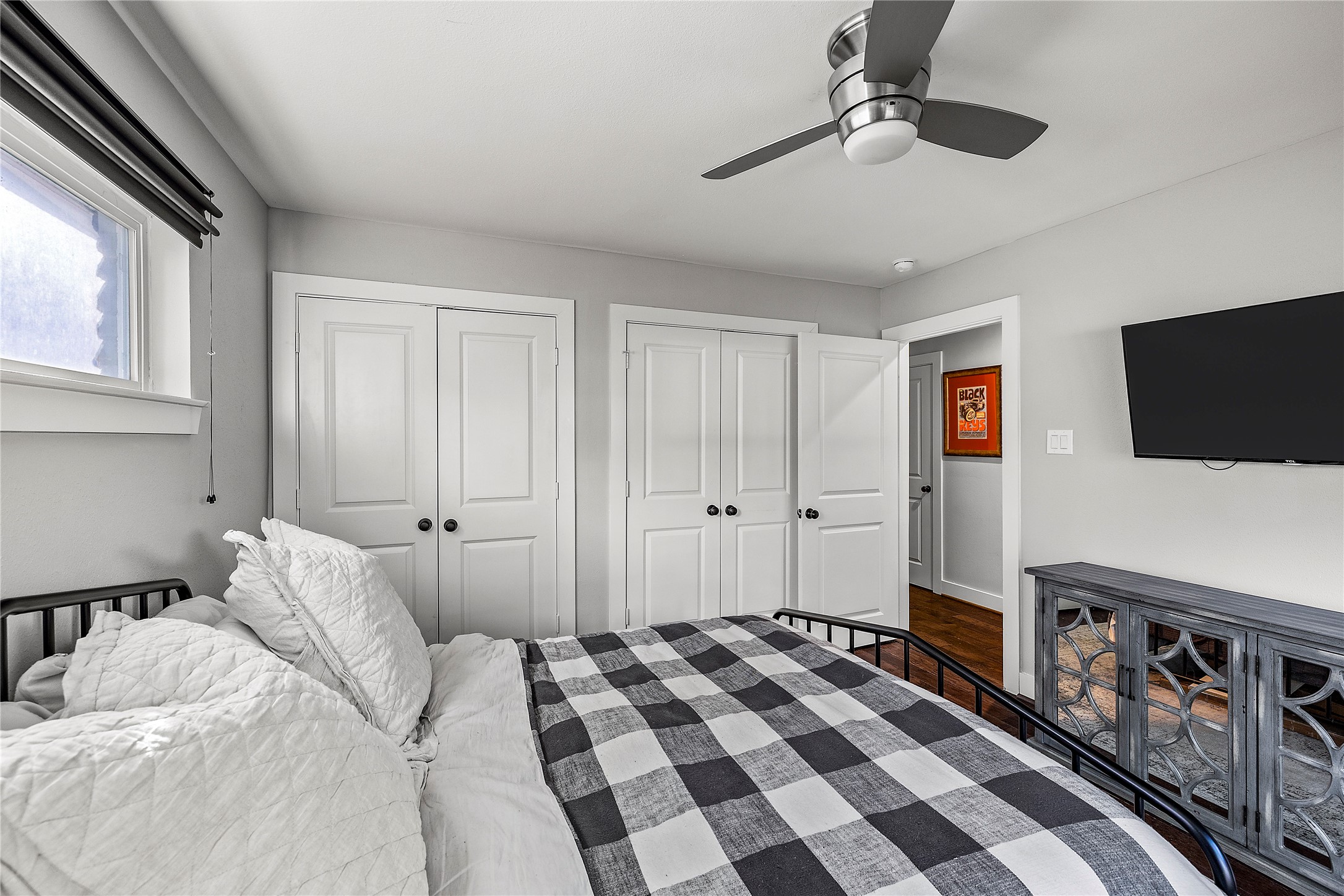 8422 Academy Street Houston, TX 77025 - Photo 27 of 47 a bedroom with a bed and a flat screen tv