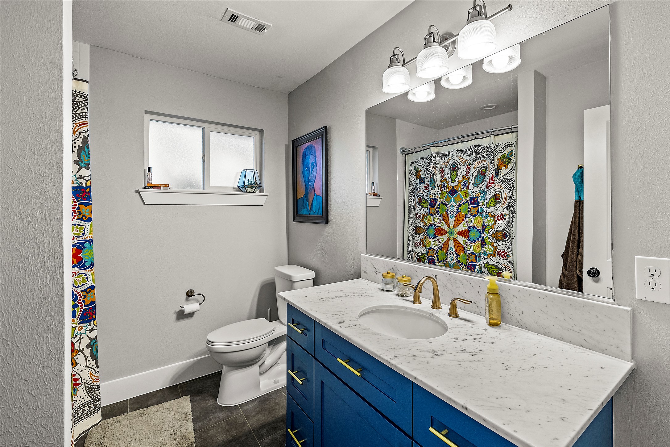 8422 Academy Street Houston, TX 77025 - Photo 28 of 47 a bathroom with a granite countertop sink a toilet and a mirror