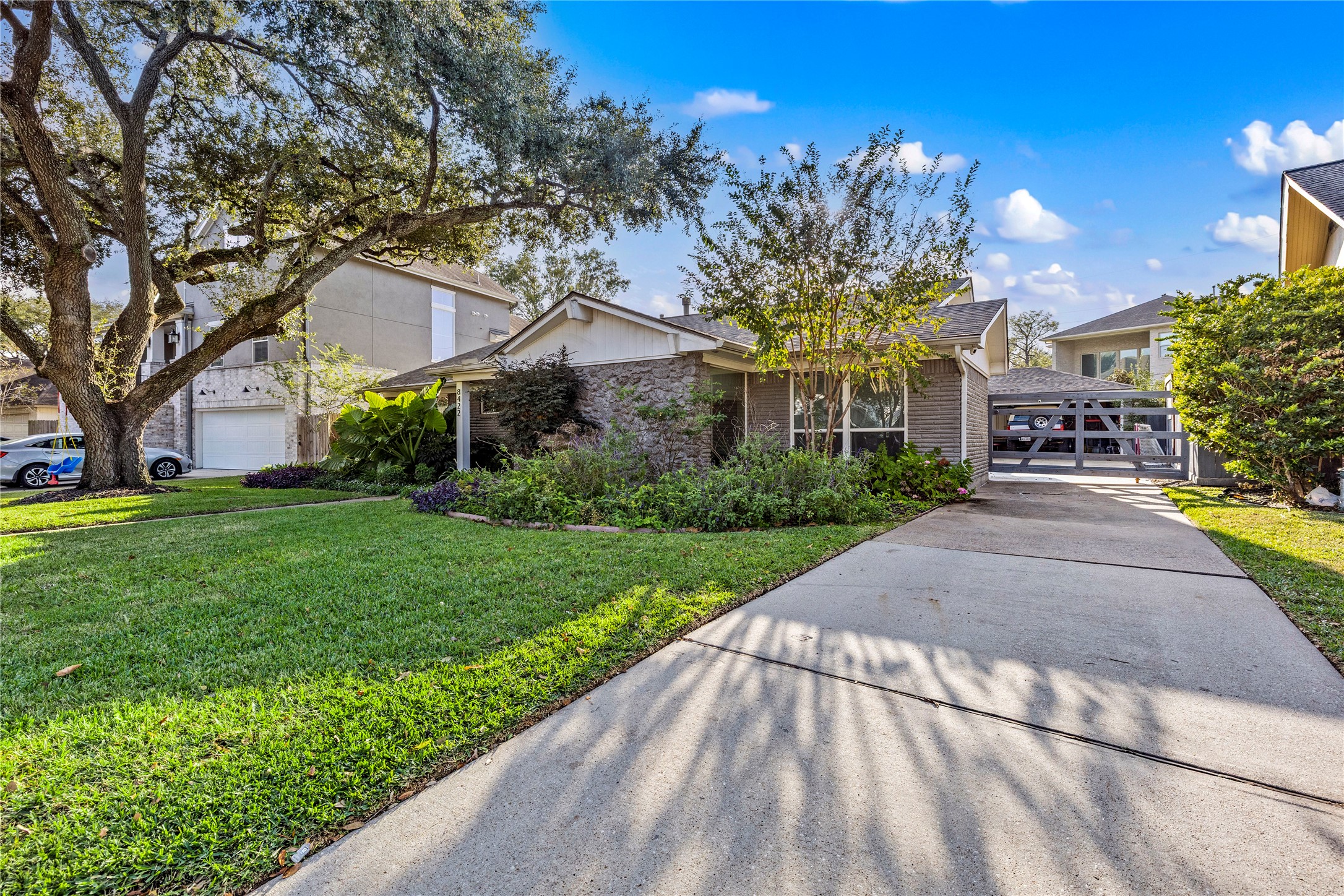 8422 Academy Street Houston, TX 77025 - Photo 47 of 47 Beautiful curb appeal continues with a wide long driveway, manicured lawn, and mature trees offering shade and character. A peaceful, picture perfect setting in a well established neighborhood.