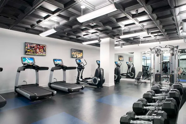 a room with gym equipment and a large mirror