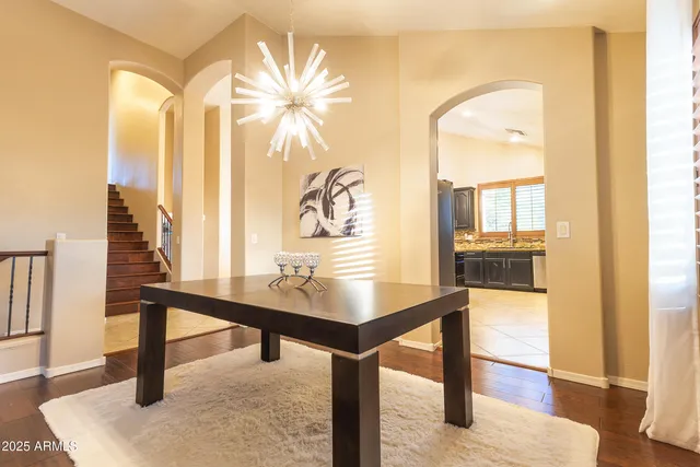 a view of a living room with a table and chairs