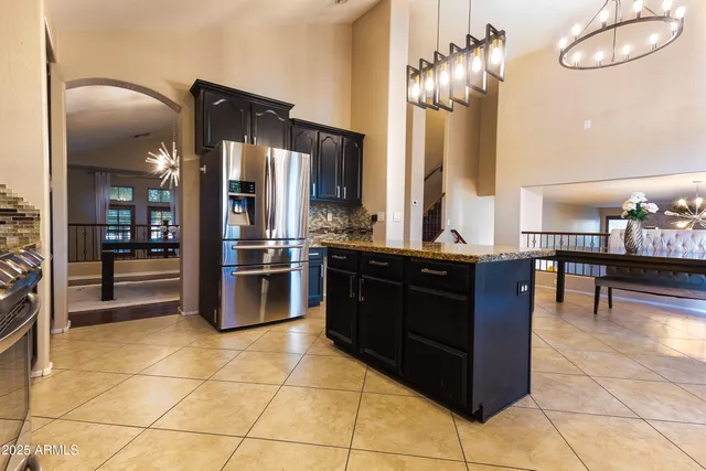 a kitchen with stainless steel appliances granite countertop a refrigerator and a sink