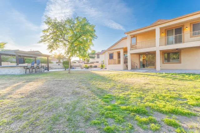 a house view with swimming pool in front of it