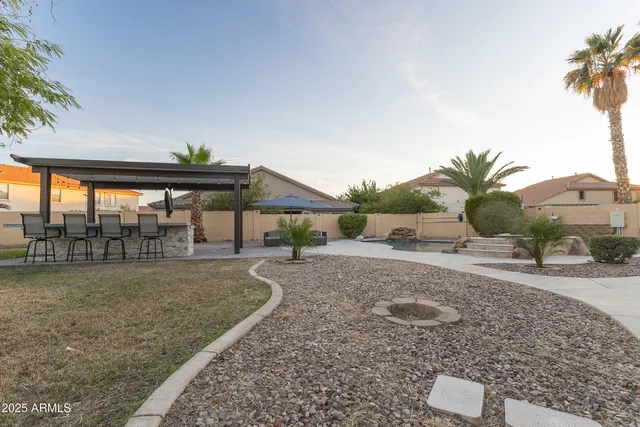 a backyard of a house with table and chairs