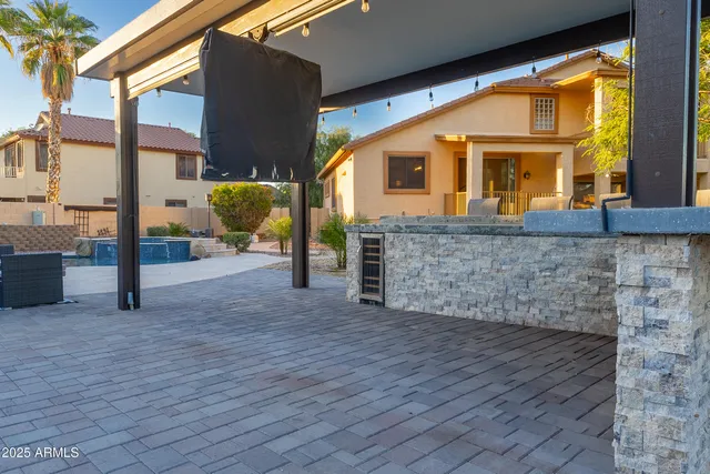 a view of an house with backyard and sitting area