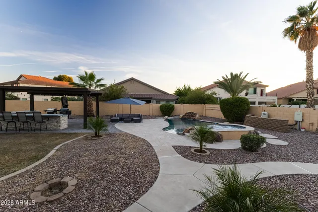 a view of a backyard with sitting area