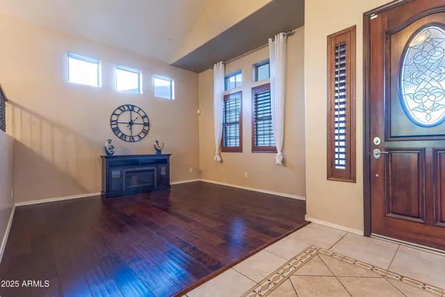 an empty room with window and wooden floor