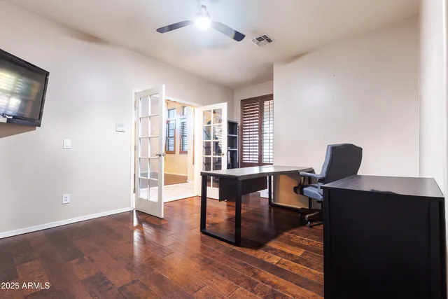 a view of a workspace with furniture and a window