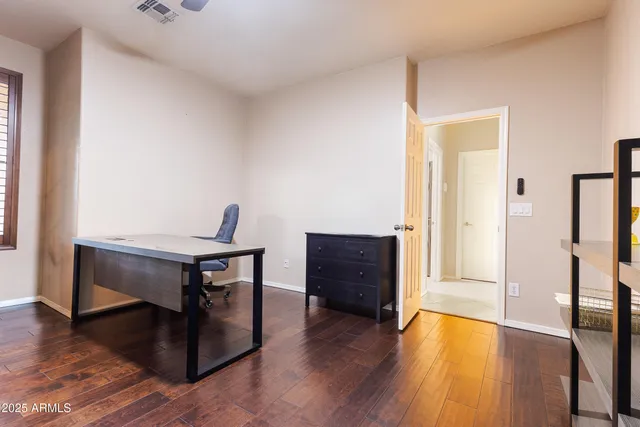 a view of a workspace with furniture and wooden floor
