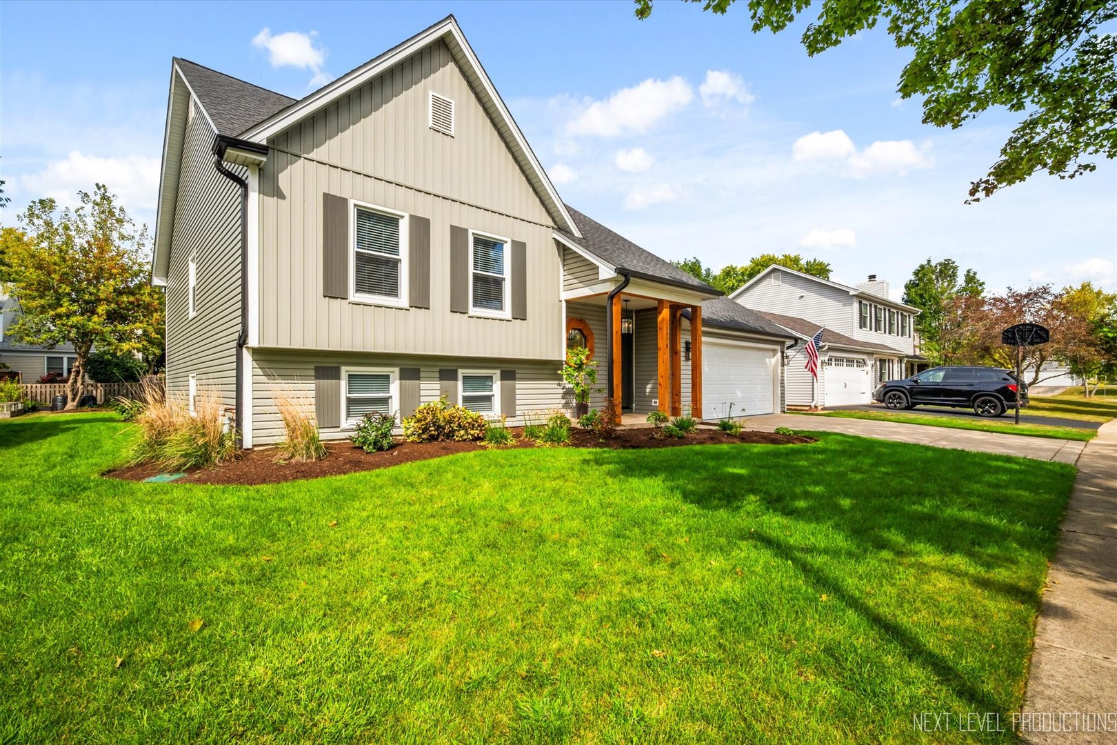 1718 Jeanette Avenue St. Charles, IL 60174 - Photo 3 of 36 a view of a yard in front of a house with large tree