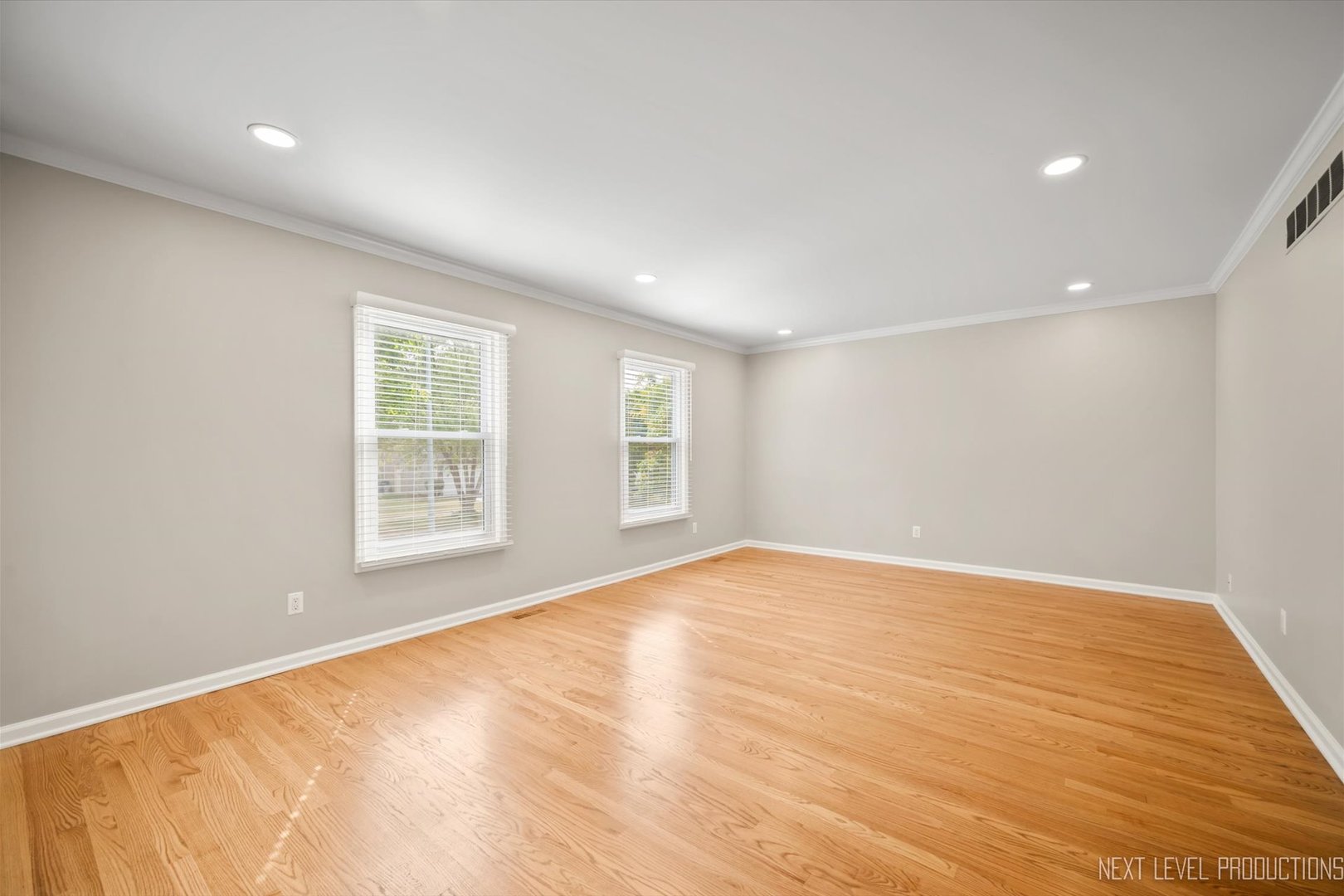 1718 Jeanette Avenue St. Charles, IL 60174 - Photo 8 of 36 an empty room with wooden floor and windows