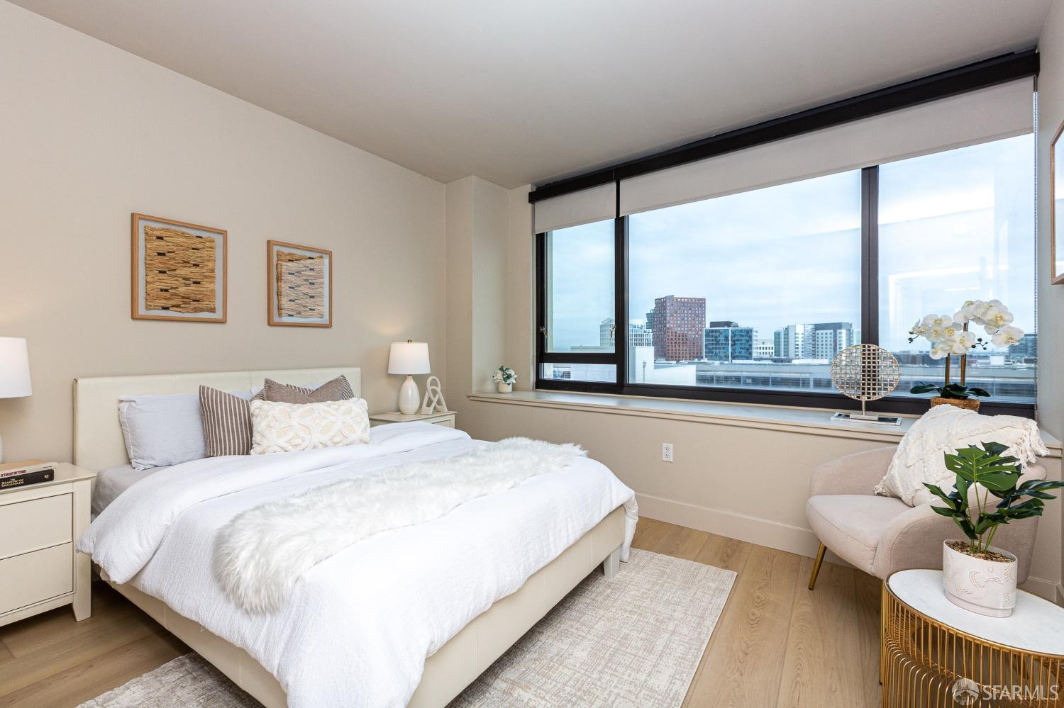 260 King Street, Unit 1107 San Francisco, CA 94107 - Photo 13 of 58 a bedroom with a bed and a large window with outer view