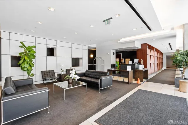 a living room with furniture and a potted plant