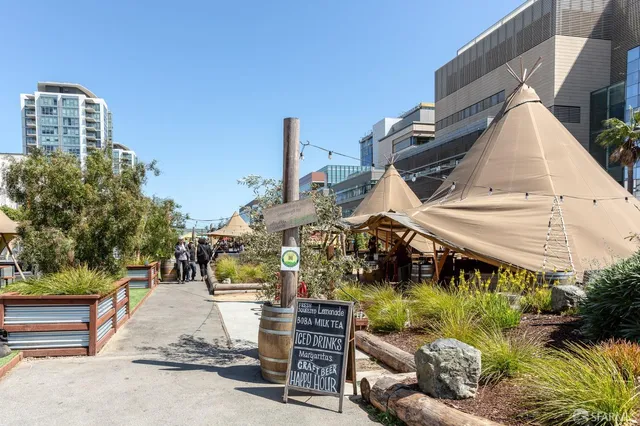 a view of a patio with table and chairs potted plants