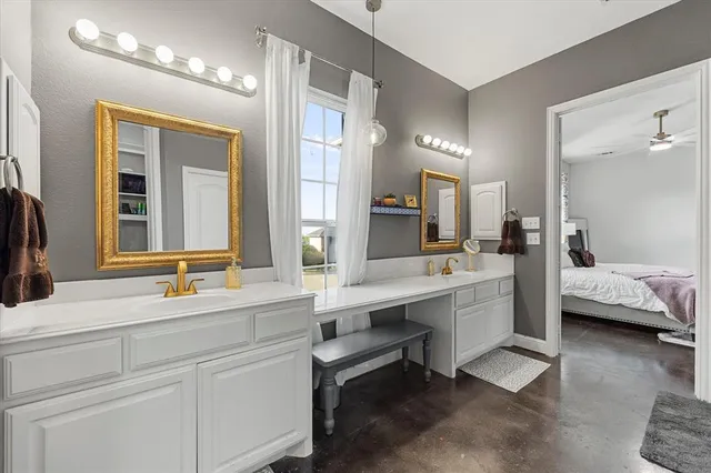 a bathroom with a double vanity sink a mirror and a bathtub