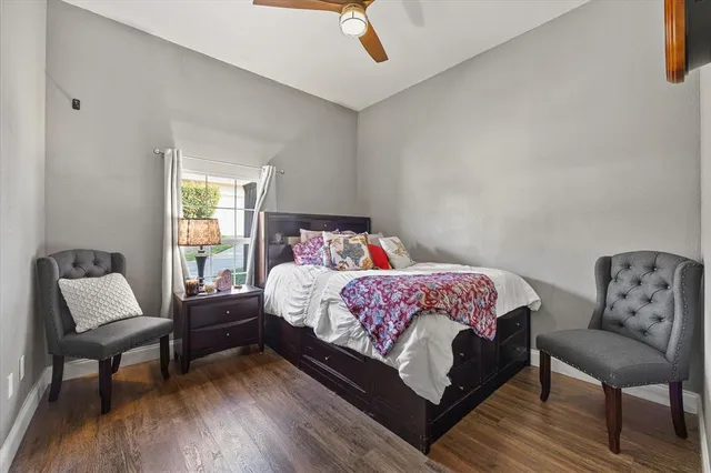 a bedroom with a bed a table and chair