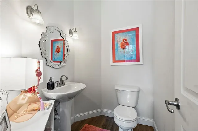 a bathroom with a toilet sink and mirror