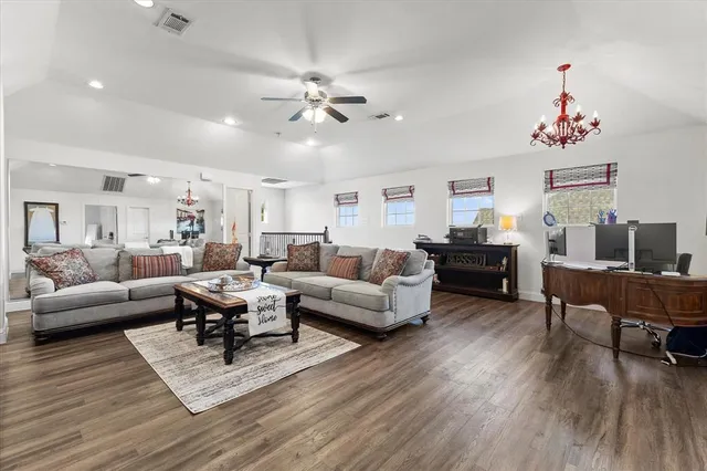 a living room with furniture and wooden floor