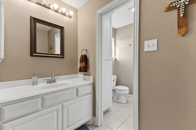 a bathroom with a toilet a sink and mirror