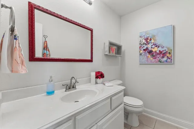 a bedroom with a bed table and two window