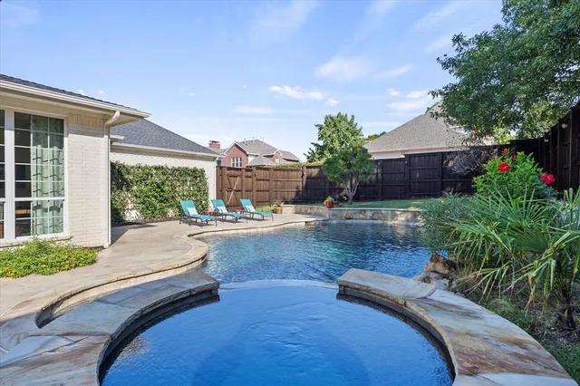 a view of a house with backyard and sitting area