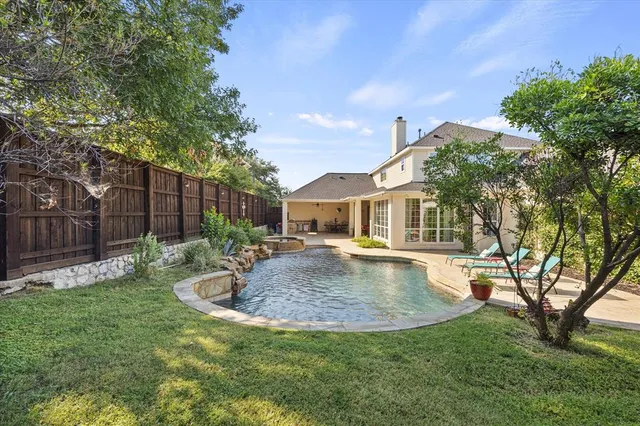 an aerial view of a city with lots of residential buildings ocean and mountain view in back
