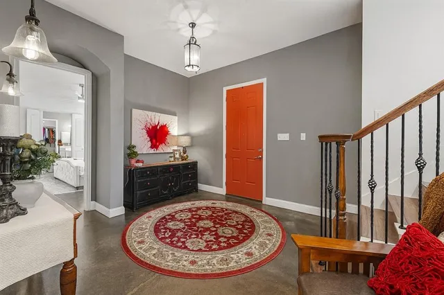 a living room with furniture and a chandelier