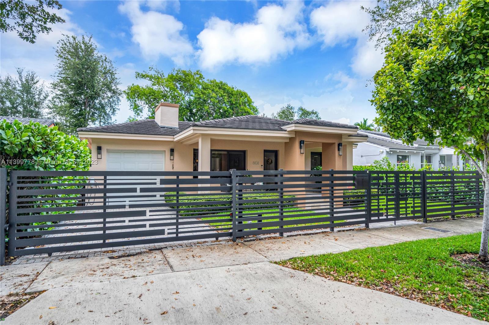 801 Southwest 28th Road Miami, FL 33129 - Photo 1 of 40 a front view of a house with a garden