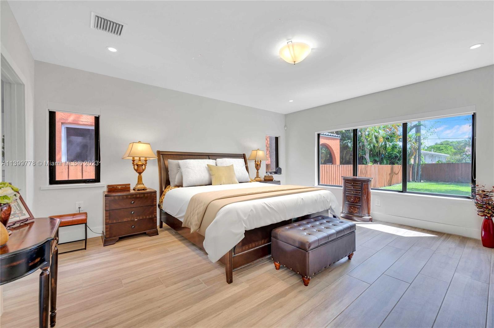 801 Southwest 28th Road Miami, FL 33129 - Photo 18 of 40 a spacious bedroom with a bed and wooden floor