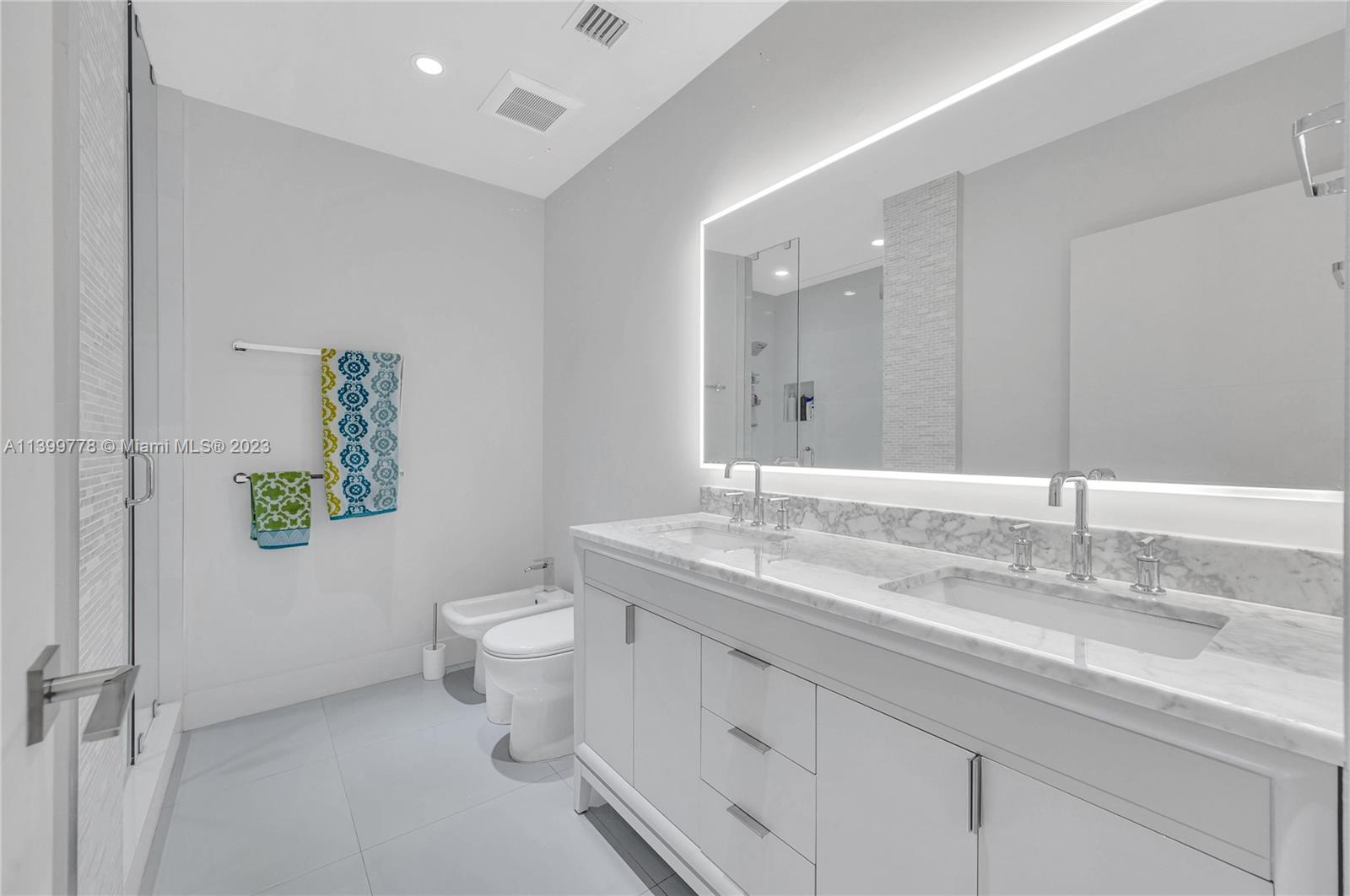 801 Southwest 28th Road Miami, FL 33129 - Photo 20 of 40 a bathroom with a granite countertop toilet sink and mirror