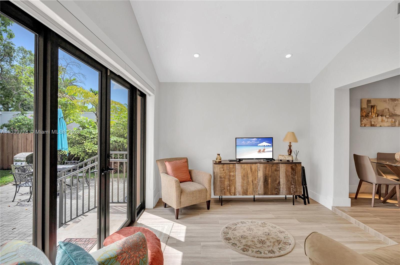 801 Southwest 28th Road Miami, FL 33129 - Photo 22 of 40 a living room with furniture and a floor to ceiling window