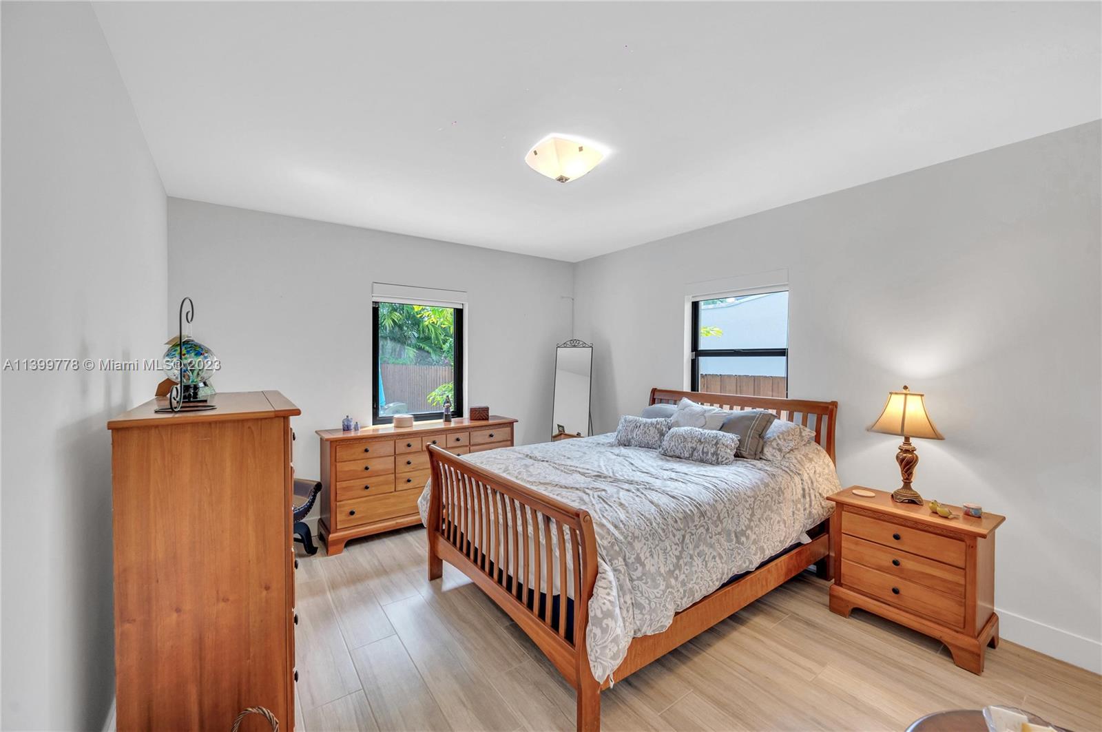 801 Southwest 28th Road Miami, FL 33129 - Photo 23 of 40 a bedroom with a bed and wooden floor