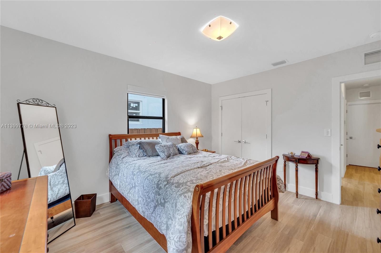 801 Southwest 28th Road Miami, FL 33129 - Photo 24 of 40 a bedroom with a bed and wooden floor