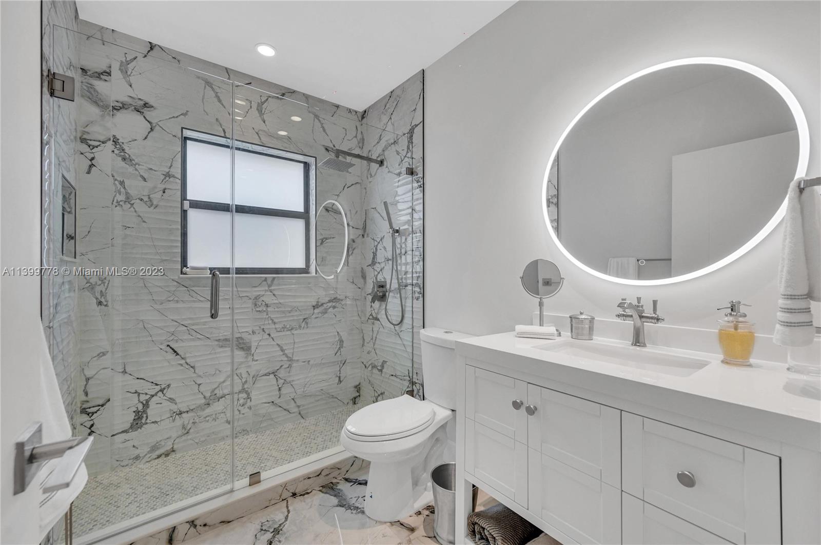 801 Southwest 28th Road Miami, FL 33129 - Photo 25 of 40 a bathroom with a toilet sink double vanity and mirror