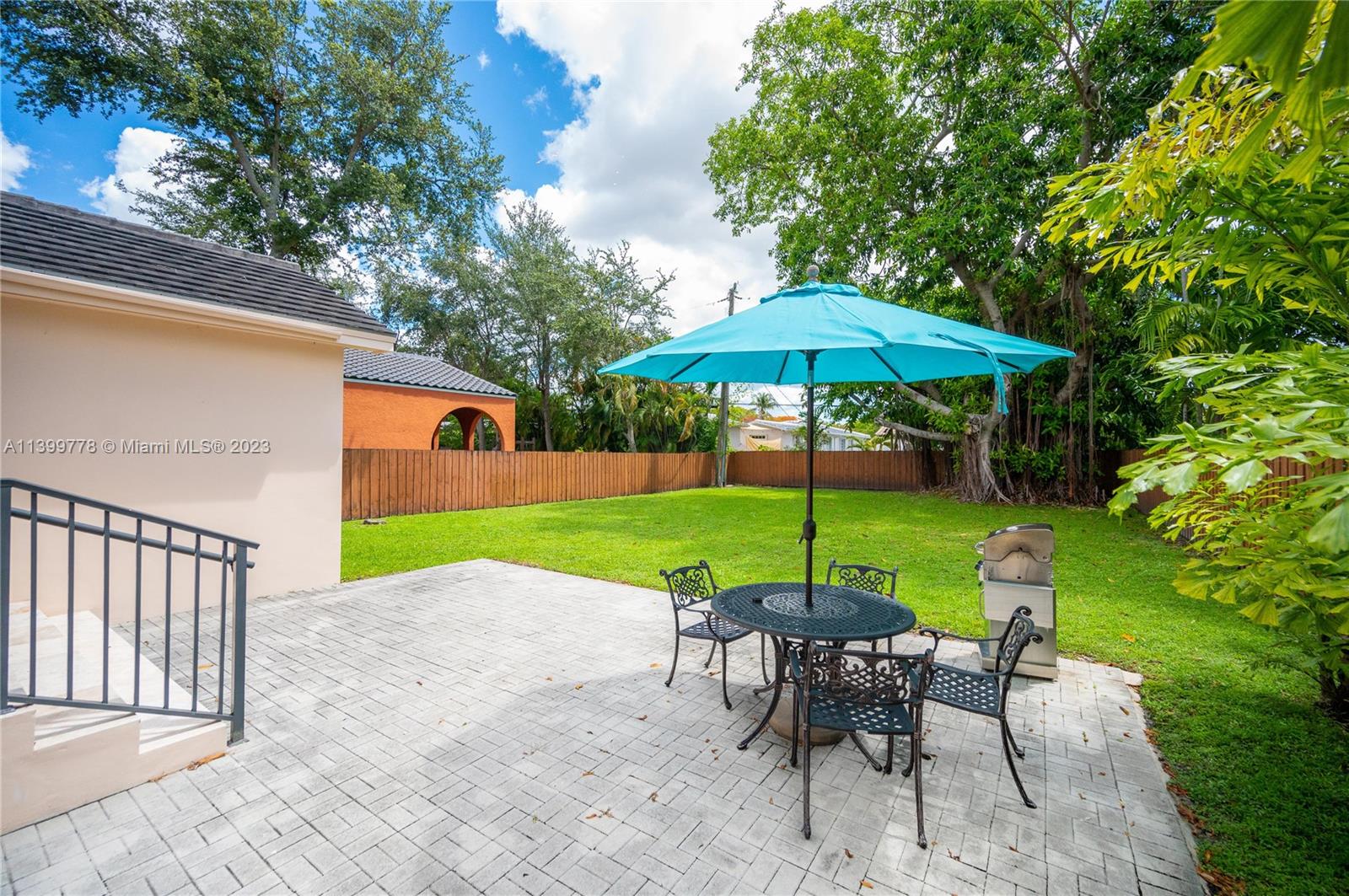 801 Southwest 28th Road Miami, FL 33129 - Photo 29 of 40 a view of pool with table and chairs under an umbrella