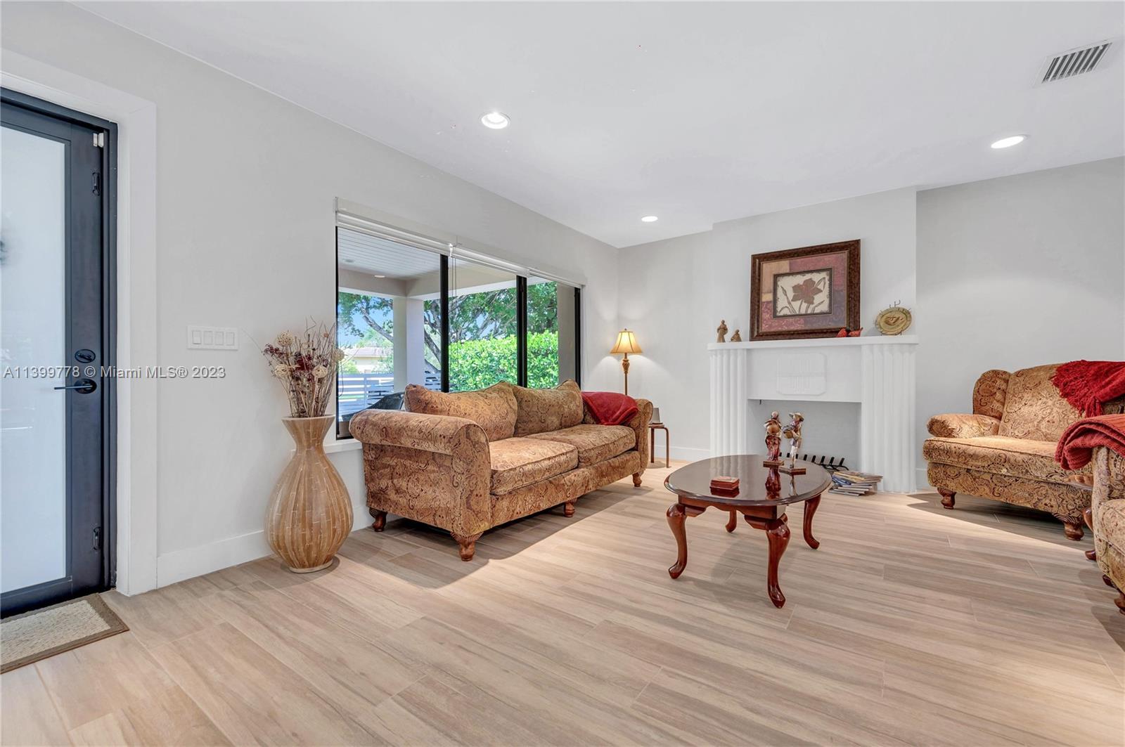 801 Southwest 28th Road Miami, FL 33129 - Photo 6 of 40 a living room with furniture and a wooden floor