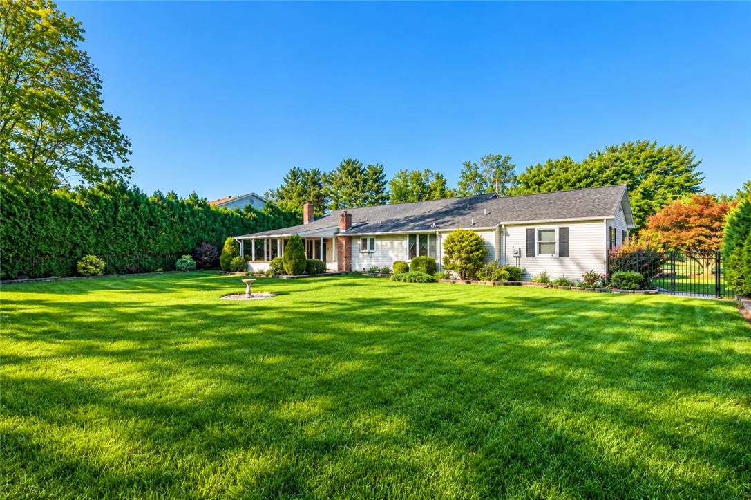 3915 Hecktown Road Bethlehem, PA 18020 - Photo 11 of 42 A spacious, manicured lawn frames the back of this classic single-story home.