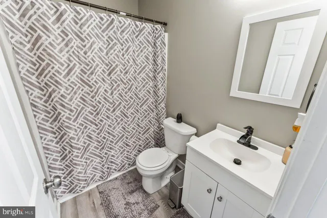 a bathroom with a toilet sink and mirror