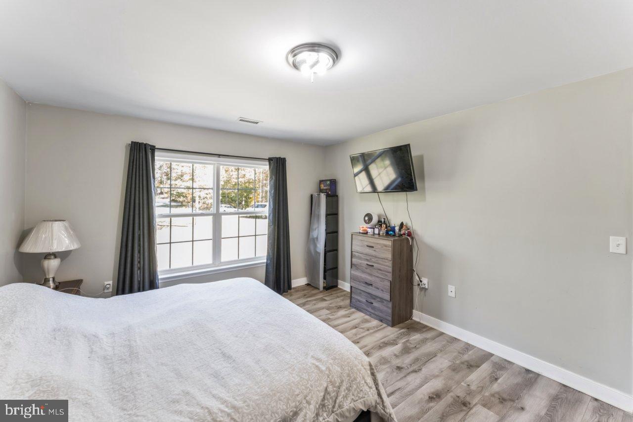 166 Bootons Lane Orange, VA 22960 - Photo 16 of 24 a bedroom with a bed and a flat tv screen on dresser