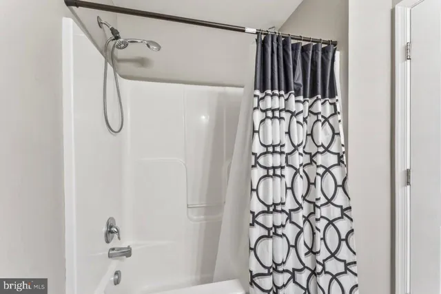 a bathroom with a shower and a shower curtain