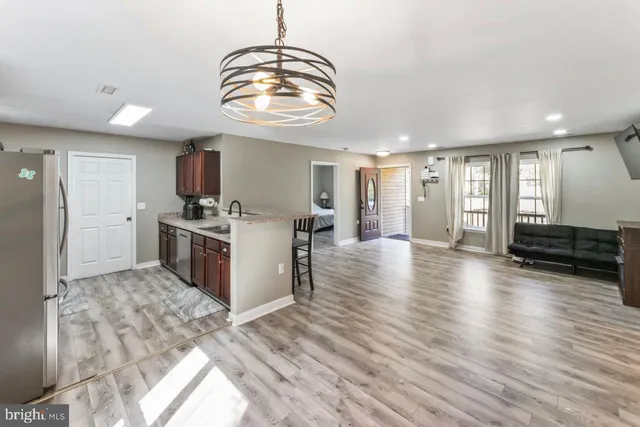 a view of a kitchen with a sink stainless steel appliances and cabinets