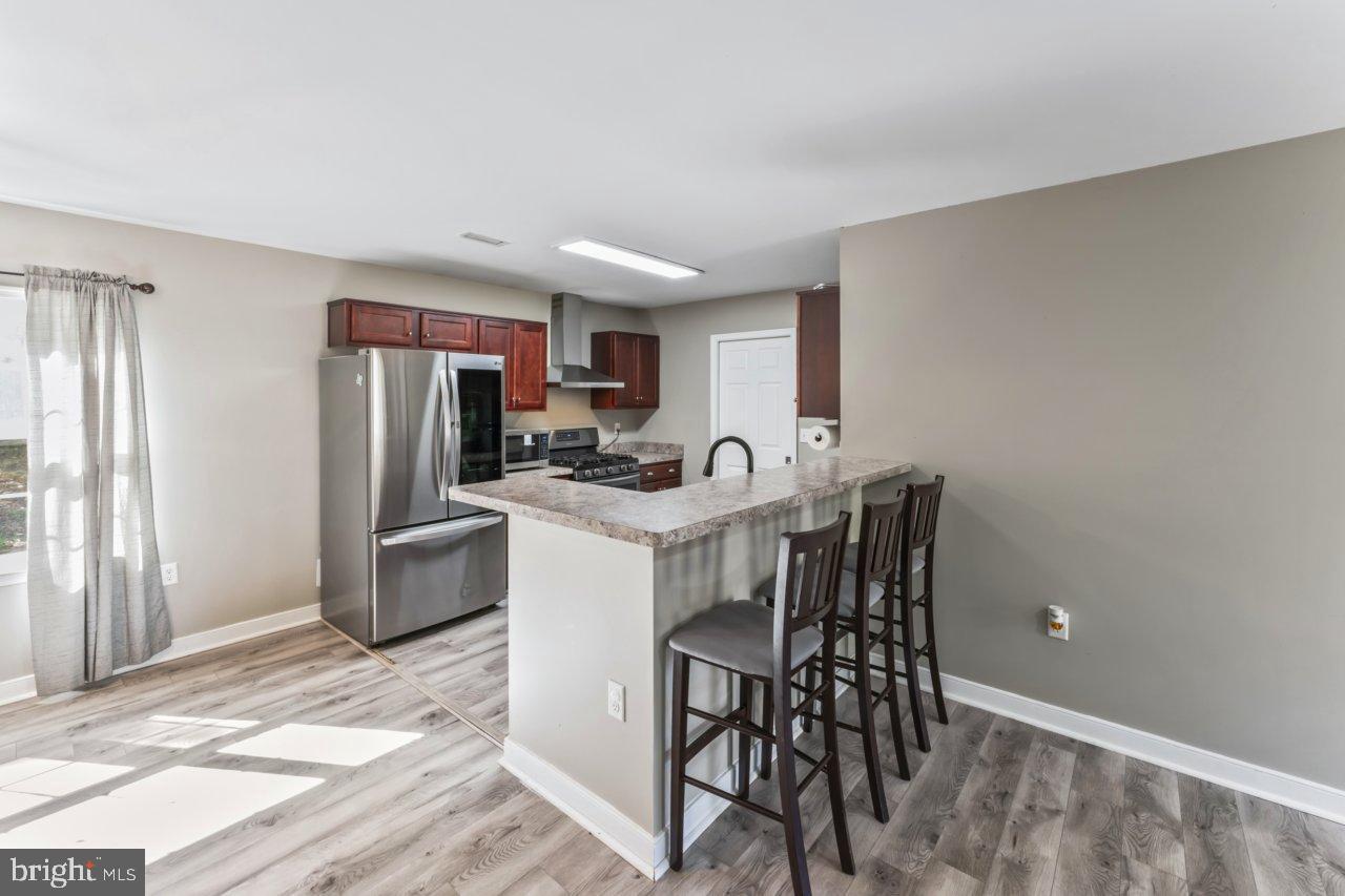 166 Bootons Lane Orange, VA 22960 - Photo 7 of 24 a kitchen that has a dining table chairs stainless steel appliances and cabinets