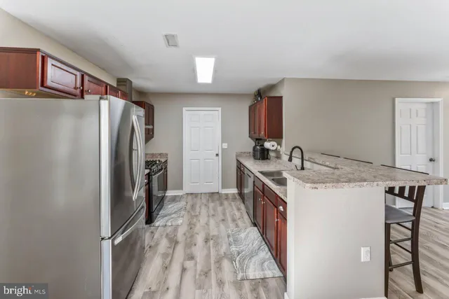 a kitchen with a sink stove and refrigerator