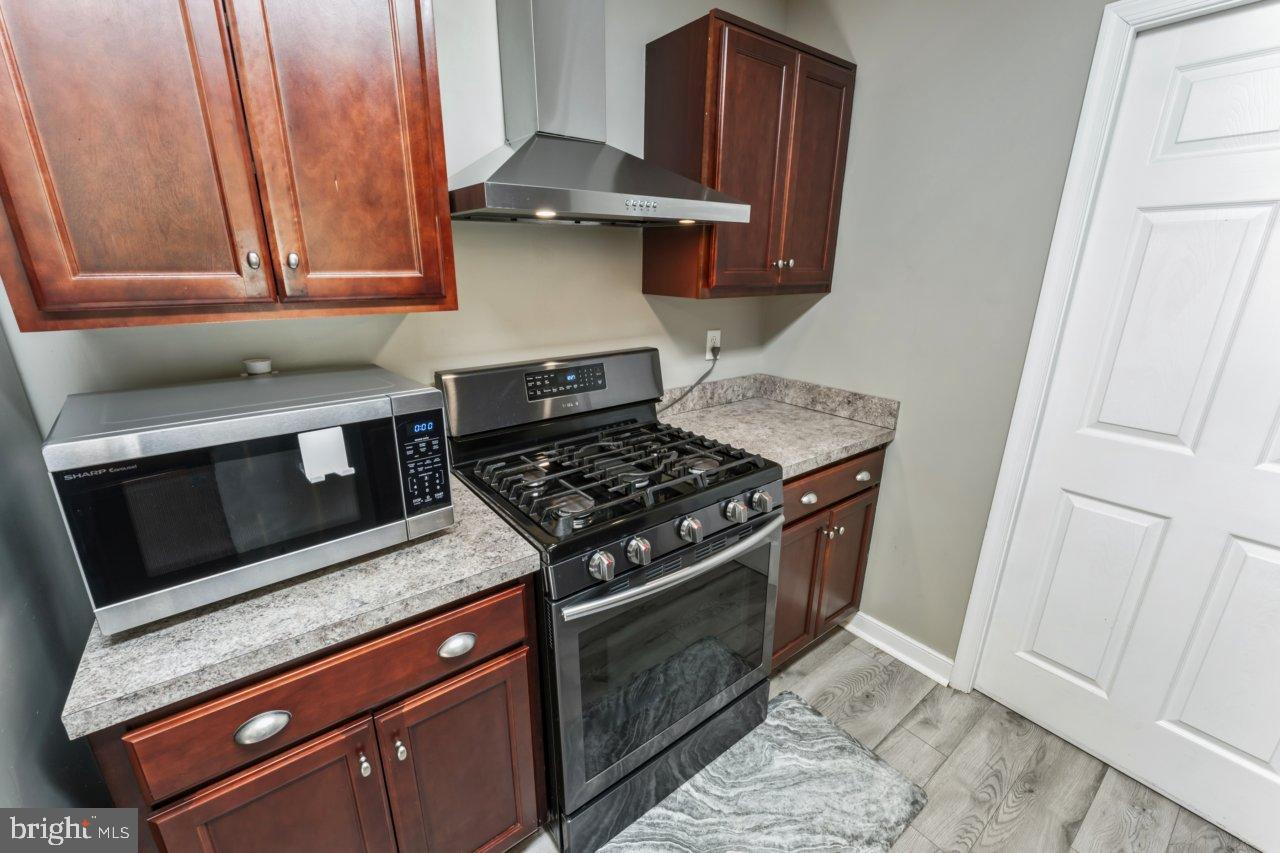 166 Bootons Lane Orange, VA 22960 - Photo 9 of 24 a kitchen with stainless steel appliances granite countertop a stove and a microwave