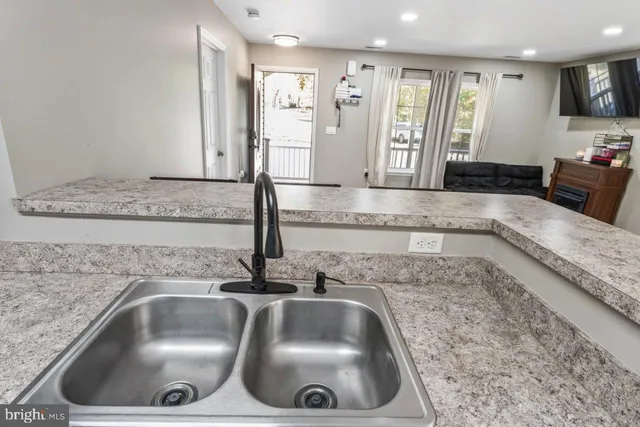a kitchen with a sink and a mirror