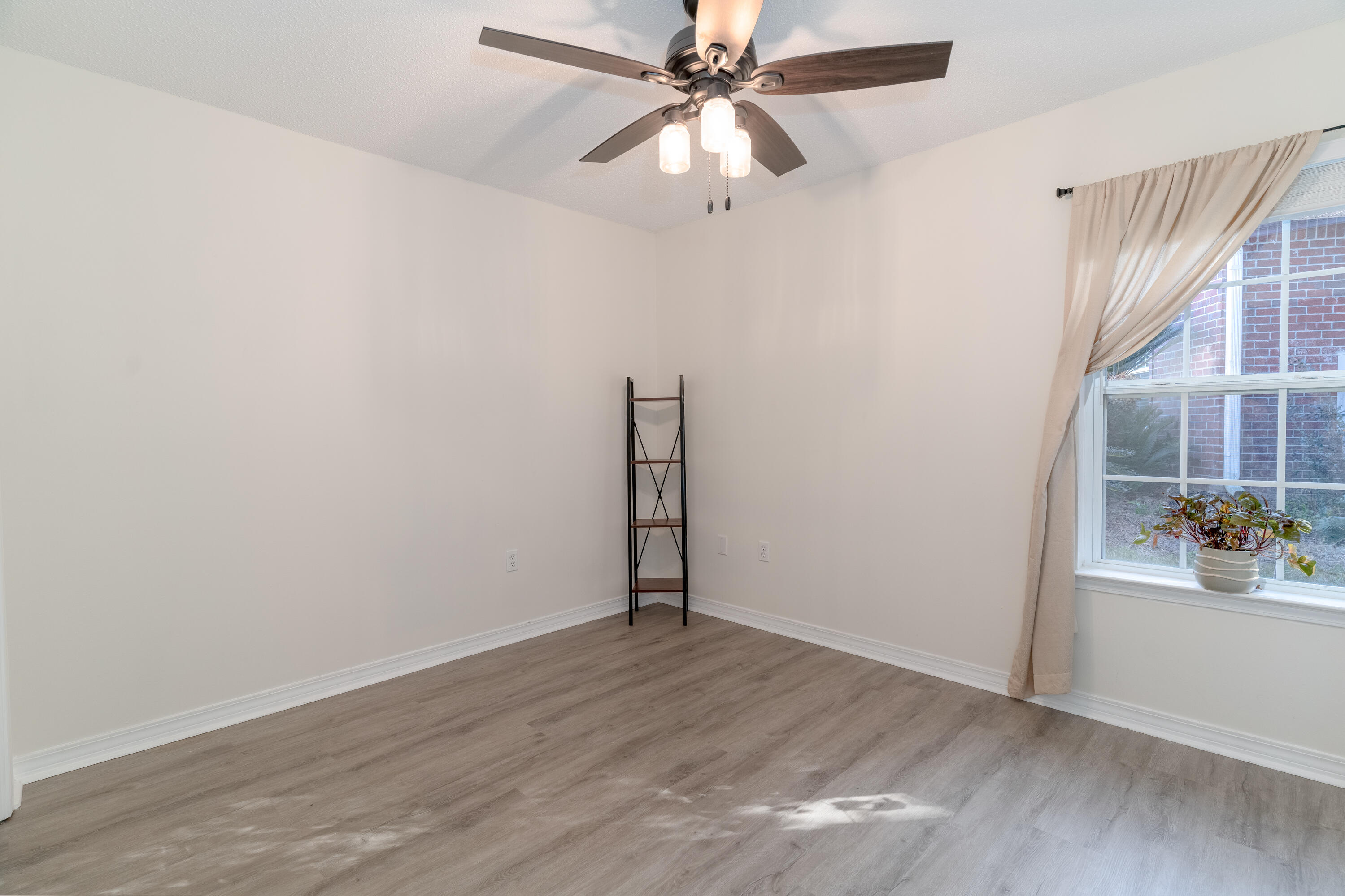 740 Riva Ridge Drive Crestview, FL 32539 - Photo 31 of 46 an empty room with wooden floor closet and fan