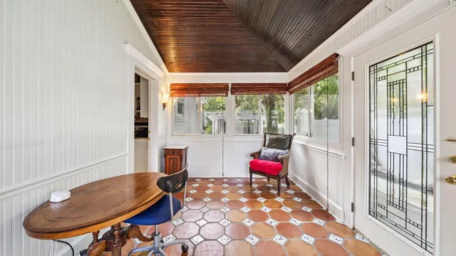 a view of a livingroom with wooden floor and staircase