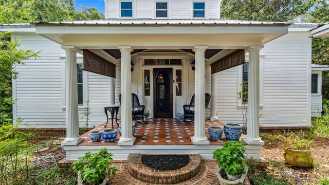 a front view of a house with plants