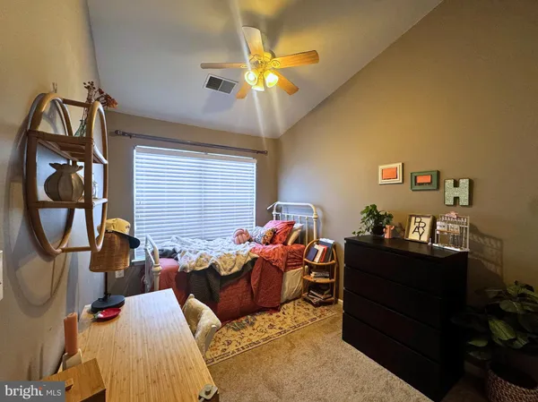 a living room with furniture a chandelier and a window