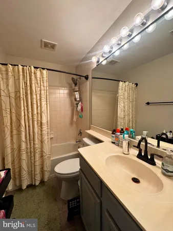 a bathroom with a sink toilet double vanity and shower